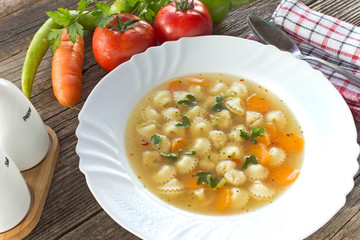 Soup with meatballs and pasta in plate