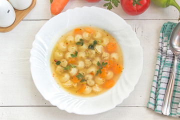 Soup with meatballs and pasta in plate