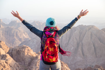girl looks at Sinai mountains at dawn
