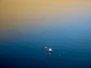 Aerial side view of oil tanker ship on open sea.