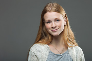 Human face expressions and emotions. Portrait of young smiling adorable redhead woman in cozy shirt looking happy and cute.