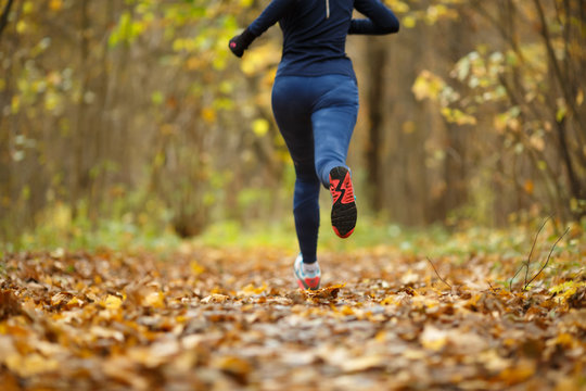 Woman in sportswear running autumn