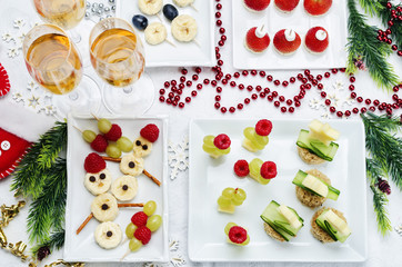 Assortment of New Year's snacks and a glass of champagne