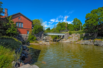 Fototapeta na wymiar Waterfall in Vanhankaupunginkoski and old power station, Helsink