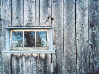 Old window in rustic barn wall