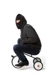 Burglar in mask on bicycle