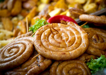 Grilled, roasted sausages on the barbecue, meat food, selective focus