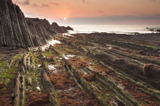 Flysch rock formations and sea at sunset, Guipuzcoa, Spain 