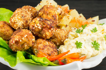 Meatballs on a plate decorated with vegetables