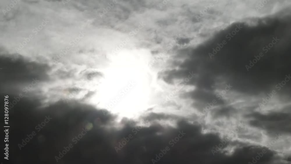 Sticker time lapse of dark rain clouds overtaking sunny sky with rain falling.