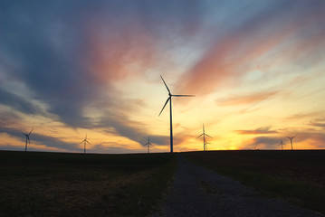 wind mill called wind farm at the sunset with dramatic sky
