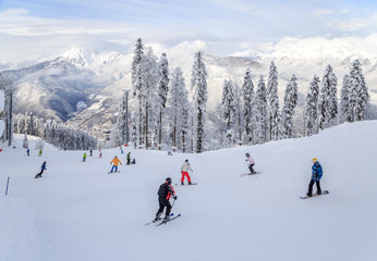 Skiers and snowboarders riding on a ski slope