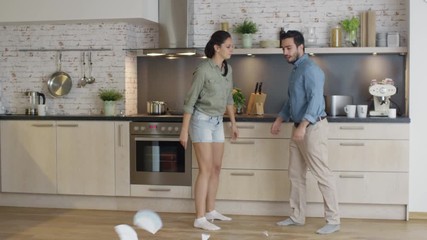 Young Couple Quarrels in the Kitchen. Girl Had Enough and She Breaks the Plate. Man Screams in Frustration and Angrily Gesticulates. Shot on RED Cinema Camera in 4K (UHD). - Powered by Adobe