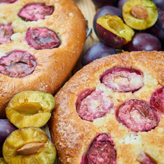 Home made plum buns on a wooden table