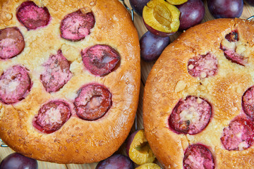 Home made plum buns on a wooden table