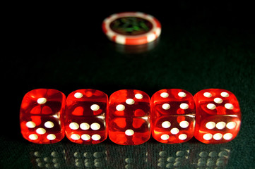 Red dice at the poker table
