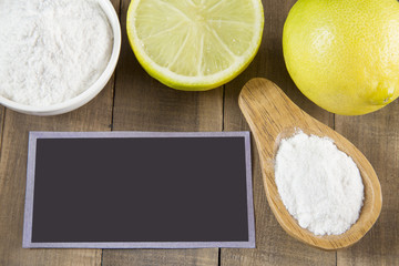 Baking soda and lemon on wooden table