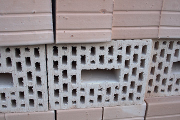Clay bricks, beige with insulating cavities, on a pile