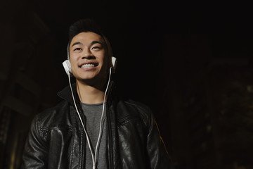 Portrait of a asian young man listening music.