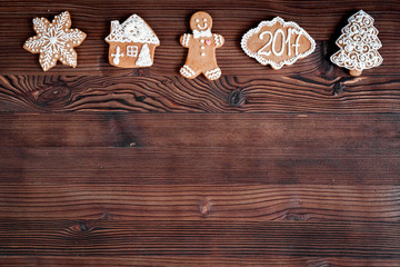 Christmas gingerbread, spruce branches on dark wooden background top view