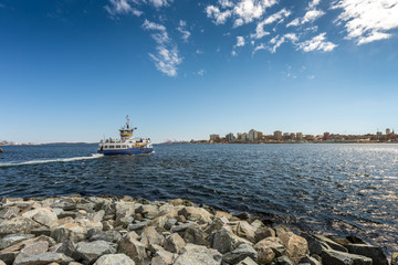Ferry departing for Halifax from Dartmouth under deep blue sky with some clouds - obrazy, fototapety, plakaty