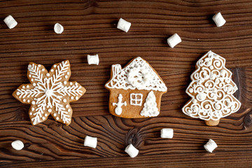 Christmas gingerbread on dark wooden background top view
