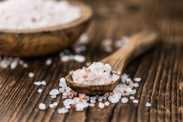 Portion of Himalayan Salt on wooden background (selective focus)