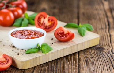 Tomato Ketchup (selective focus) on vintage wooden background