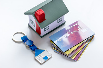 toy house, credit cards - concept mortgage on white background