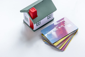 toy house, credit cards - concept mortgage on white background