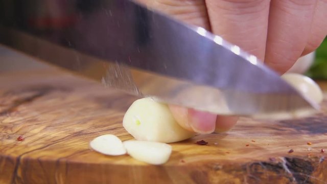 Cutting garlic on a wooden cutting board