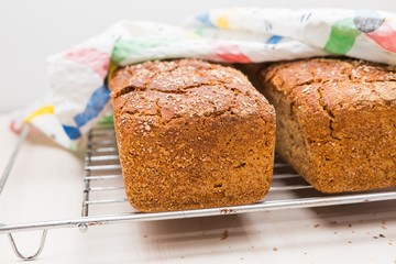 Freshly baked homemade bread lying on metal grille