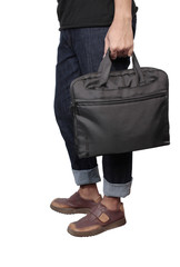 Young stylish in black trendy outfit with computer bag in hand