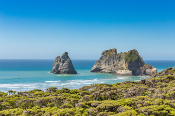 Fototapeta na wymiar Bizarre rocks on Wharariki beach, Cape Farewell. The most northerly point on the South Island of New Zealand