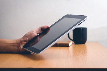 Man with modern mobile phone in hands touching on a blank screen