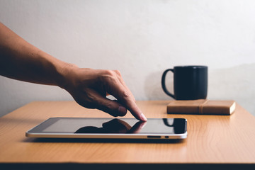 Man with modern mobile phone in hands touching on a blank screen