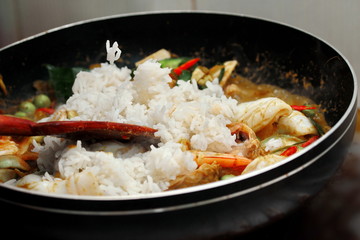 Cooking ,Fried jasmine rice in green curry with mixed meat.