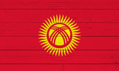 Flag of Kyrgyzstan on wooden background