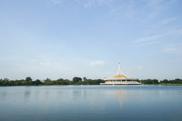 Pavilion at the riverside in the park with watercycle in front