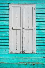 Close up Wooden window and green wooden battens background