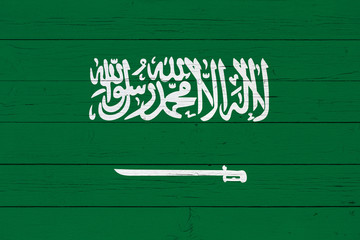 Flag of Saudi Arabia on wooden background
