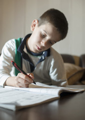 Fototapeta na wymiar Child do his homework. Hand hold pen. Boy learning