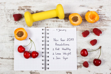 Naklejka na ściany i meble New year resolutions written in notebook on old board
