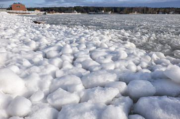 Lumps of snow and ice frazil on the surface of the freezing rive
