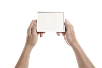 Two hands hold a photo(picture) iron(silver) frame isolated white.