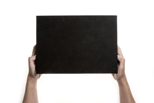 Two hands hold a empty(blank) black gift box isolated white