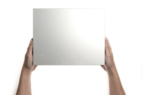 Two hands hold a empty(blank) silver(stainless) gift box isolated white