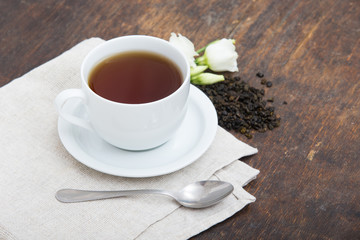 Closeup of cup of tea on vintage wooden background