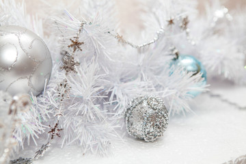 Fototapeta na wymiar New Year's toys on a white holiday tree