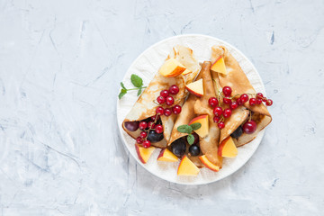 pancakes with berries in a plate on a table, selective focus,  top view